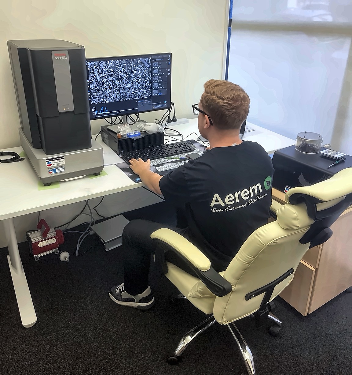 Aerem laboratory analyst operating the Phenom XL scanning electron microscope